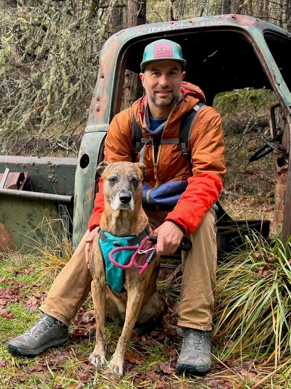 Kelly Myrkle, Certified Spinal Flow Practitioner, outdoors with his dog